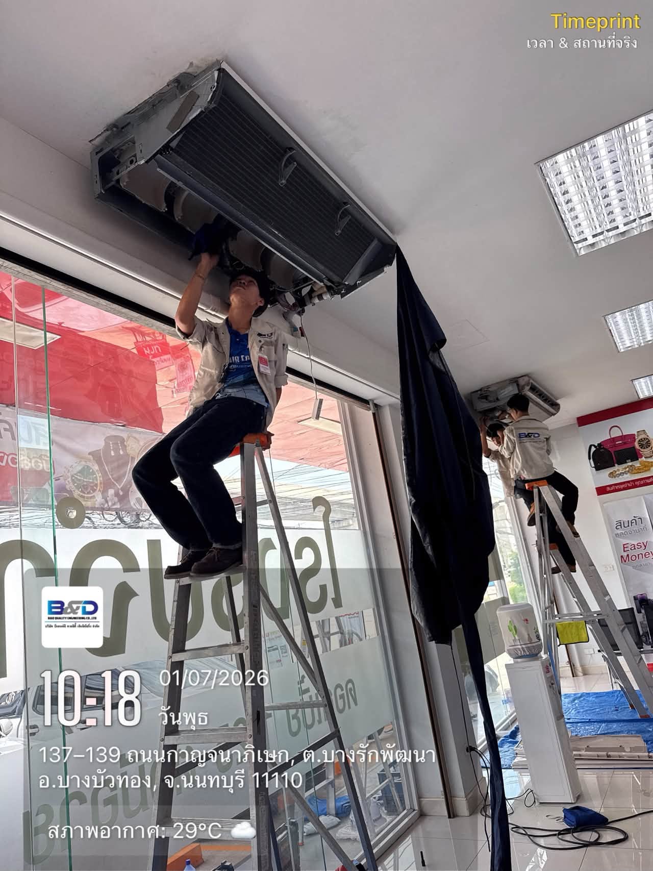 Technician working overhead on a ceiling-mounted unit